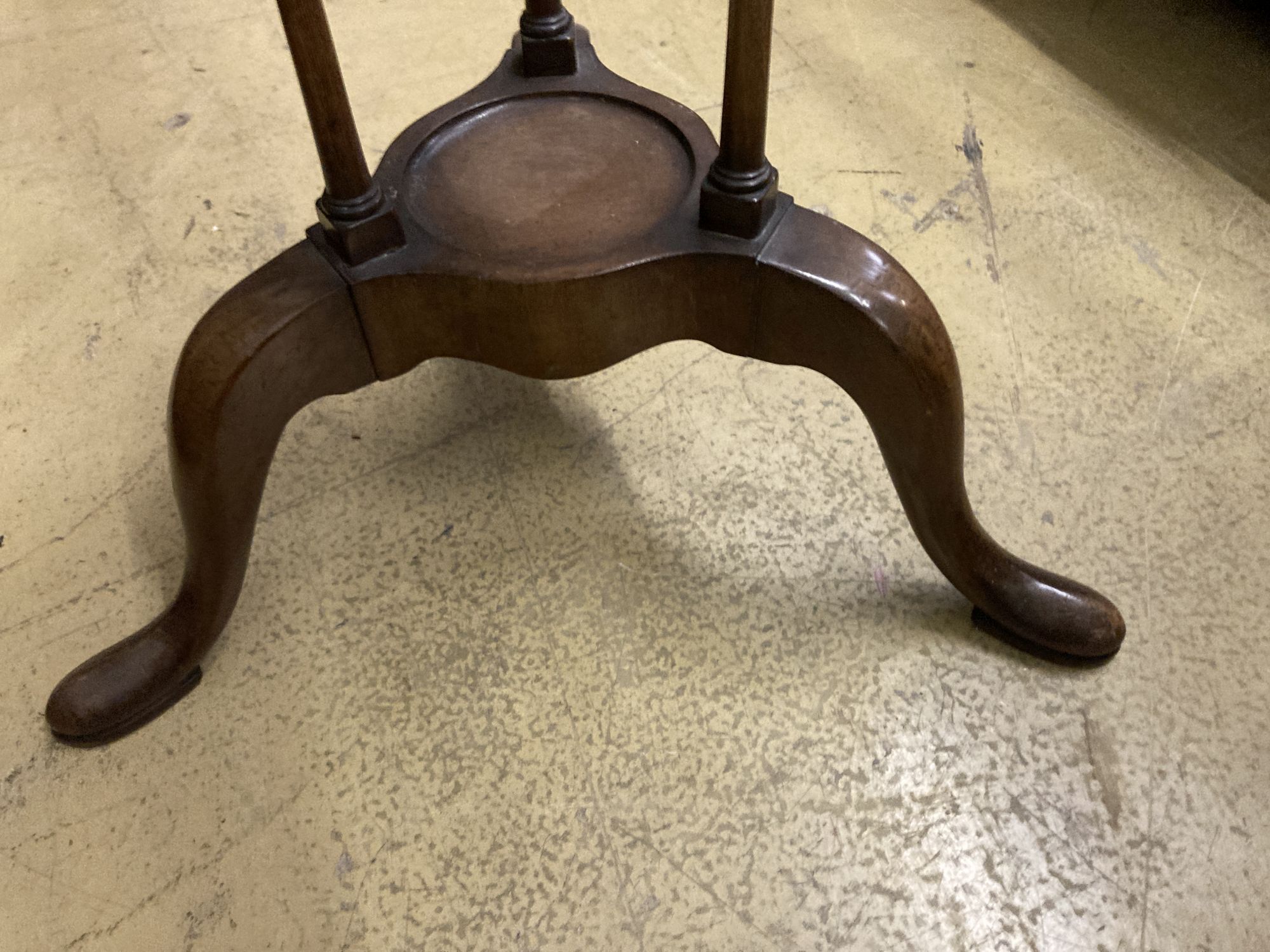 A George II style mahogany washstand, with open bowl stand over two triangular soap drawers and a jug platform, raised on cabriole legs